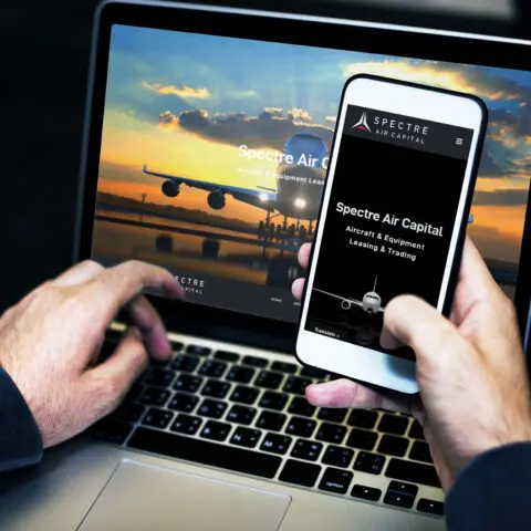 Businessman using a laptop and a mobile phone mockup